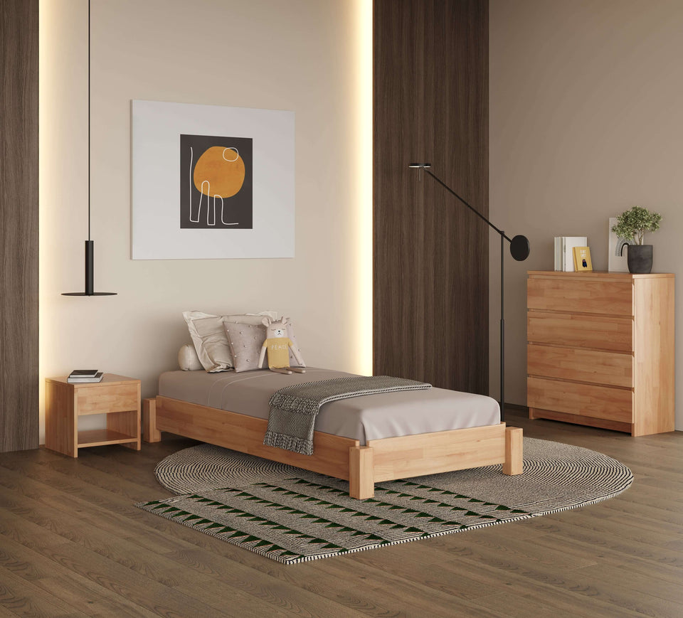Stella solid beech bed in modern bedroom with bedside table and chest of drawers