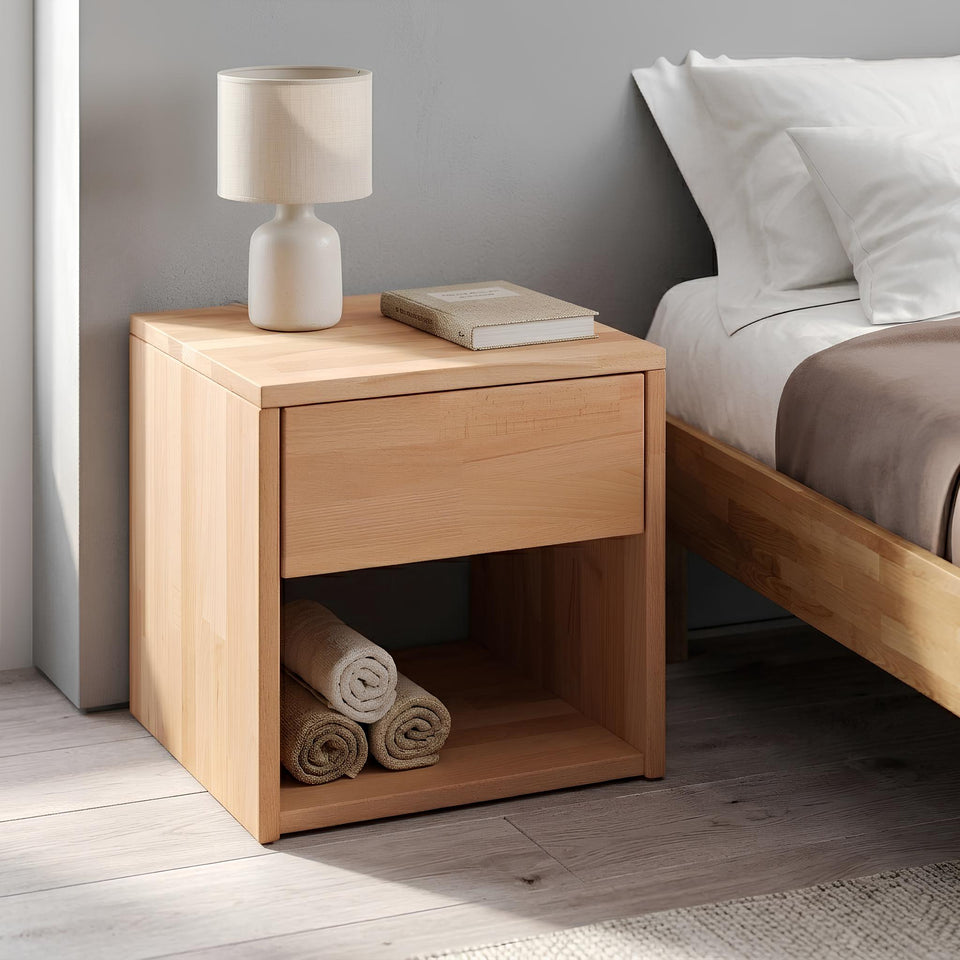 Beech wood bedside table in the bedroom next to the bed