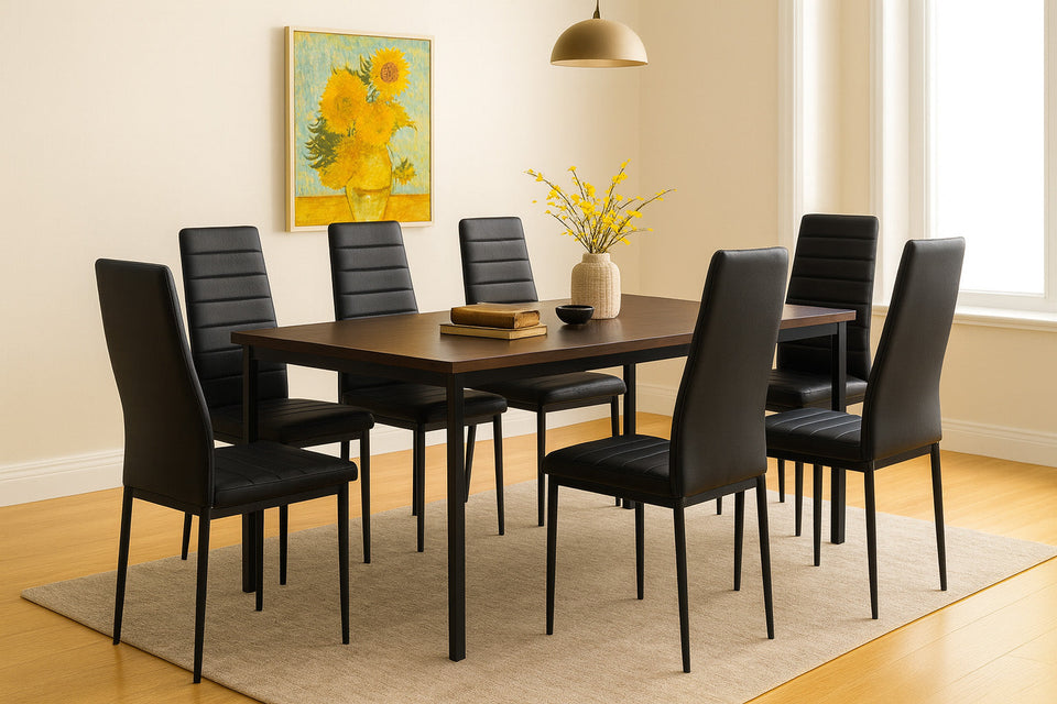 Dining room with a wooden table and black chairs, featuring a painting and vase on the wall.
