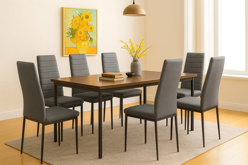 Dining room with a wooden table and gray chairs, featuring a yellow floral painting on the wall.